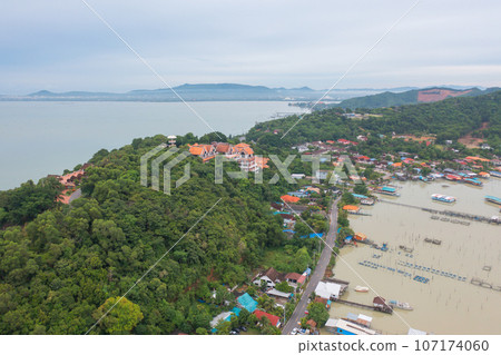 Aerial view of fishing trap net in canel with fisherman urban city village town houses, lake or river. Nature landscape fisheries and fishing tools at Pak Pha, Songkhla, Thailand. Aquaculture farming Aerial view of fishing trap net in canel with fisherman urban city village town houses, lake or river. Nature landscape fisheries and fishing tools at Pak Pha, Songkhla, Thailand. Aquaculture farming 107174060