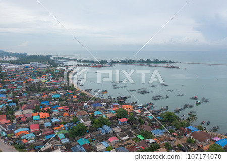 Aerial view of fishing trap net in canel with fisherman urban city village town houses, lake or river. Nature landscape fisheries and fishing tools at Pak Pha, Songkhla, Thailand. Aquaculture farming Aerial view of fishing trap net in canel with fisherman urban city village town houses, lake or river. Nature landscape fisheries and fishing tools at Pak Pha, Songkhla, Thailand. Aquaculture farming 107174070