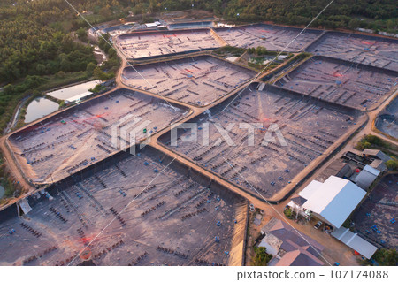 Aerial view of natural sea salt ponds, lake or sea. Farm field outdoor in traditional industry in Thailand. Asia culture. Agriculture irrigation. River reflection. 107174088