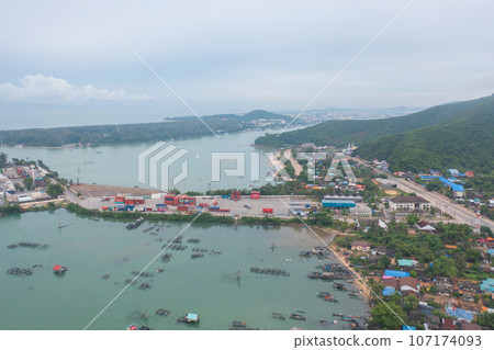 Aerial view of fishing trap net in canel with fisherman urban city village town houses, lake or river. Nature landscape fisheries and fishing tools at Pak Pha, Songkhla, Thailand. Aquaculture farming 107174093
