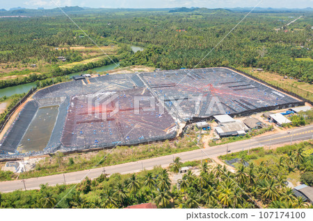 Aerial view of natural sea salt ponds, lake or sea. Farm field outdoor in traditional industry in Thailand. Asia culture. Agriculture irrigation. River reflection. 107174100