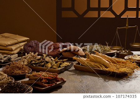 On the wooden table, different type of medicinal herbs displayed on wooden trays. Scene for medicine advertising, photography traditional medicine content. Blank space for presentation product On the wooden table, different type of medicinal herbs displayed on wooden trays. Scene for medicine advertising, photography traditional medicine content. Blank space for presentation product 107174335