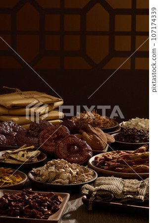 Traditional folk medicines are displayed on wooden trays. Behind are traditional brown window frames and medicine packages. Photography traditional medicine content 107174339