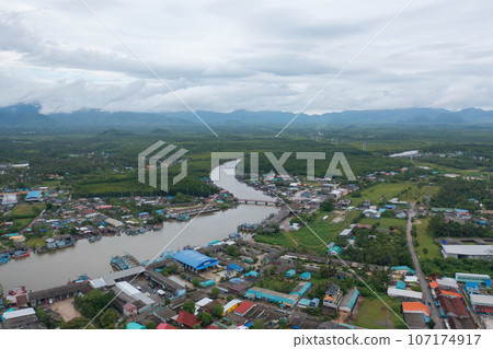 Aerial view of fishing trap net in canel with fisherman urban city village town houses, lake or river. Nature landscape fisheries and fishing tools at Pak Pha, Songkhla, Thailand. Aquaculture farming Aerial view of fishing trap net in canel with fisherman urban city village town houses, lake or river. Nature landscape fisheries and fishing tools at Pak Pha, Songkhla, Thailand. Aquaculture farming 107174917