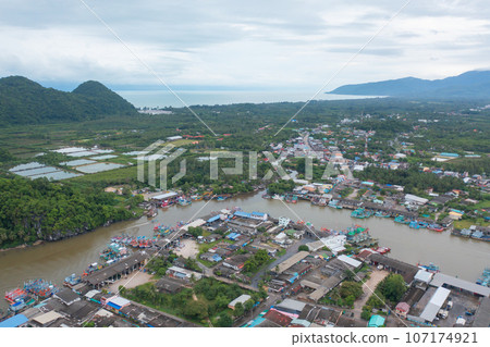 Aerial view of fishing trap net in canel with fisherman urban city village town houses, lake or river. Nature landscape fisheries and fishing tools at Pak Pha, Songkhla, Thailand. Aquaculture farming Aerial view of fishing trap net in canel with fisherman urban city village town houses, lake or river. Nature landscape fisheries and fishing tools at Pak Pha, Songkhla, Thailand. Aquaculture farming 107174921