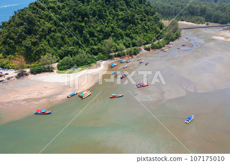 Aerial top view of tourist boats in beach shore, river, pond or lake in summer season. Nature landscape background, Thailand. Aerial top view of tourist boats in beach shore, river, pond or lake in summer season. Nature landscape background, Thailand. 107175010