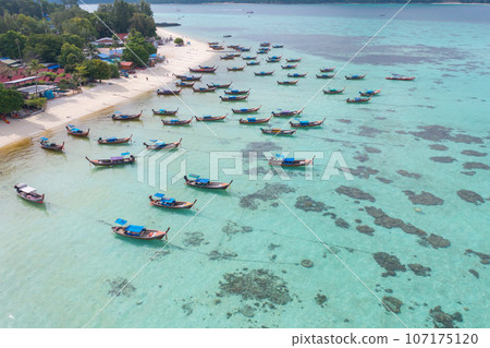 Aerial top view of tourist boats in beach shore, river, pond or lake in summer season. Nature landscape background, Thailand. Aerial top view of tourist boats in beach shore, river, pond or lake in summer season. Nature landscape background, Thailand. 107175120