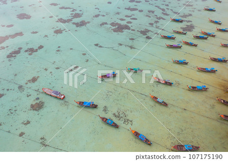 Aerial top view of tourist boats in beach shore, river, pond or lake in summer season. Nature landscape background, Thailand. 107175190