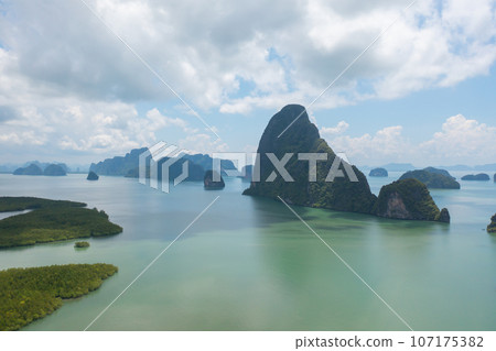 Aerial top view of Samet Nangshe, Phang Nga, lush green trees from above in tropical forest in national park in summer season. Natural landscape. Pattern texture background. Aerial top view of Samet Nangshe, Phang Nga, lush green trees from above in tropical forest in national park in summer season. Natural landscape. Pattern texture background. 107175382