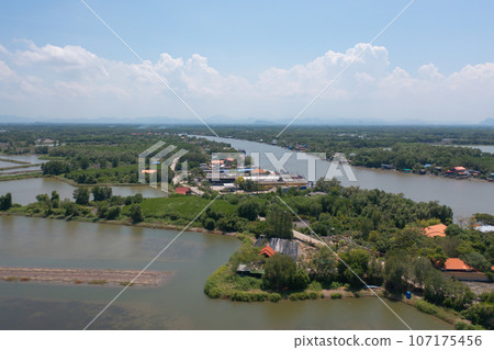 Aerial view of fishing trap net in canel with fisherman urban city village town houses, lake or river. Nature landscape fisheries and fishing tools at Pak Pha, Songkhla, Thailand. Aquaculture farming Aerial view of fishing trap net in canel with fisherman urban city village town houses, lake or river. Nature landscape fisheries and fishing tools at Pak Pha, Songkhla, Thailand. Aquaculture farming 107175456