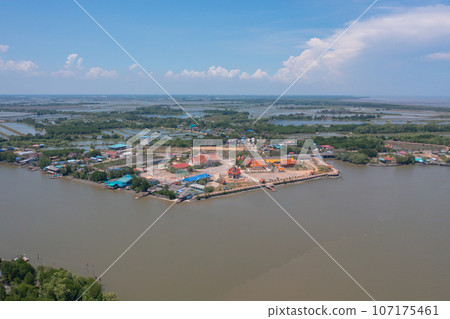 Aerial view of fishing trap net in canel with fisherman urban city village town houses, lake or river. Nature landscape fisheries and fishing tools at Pak Pha, Songkhla, Thailand. Aquaculture farming 107175461