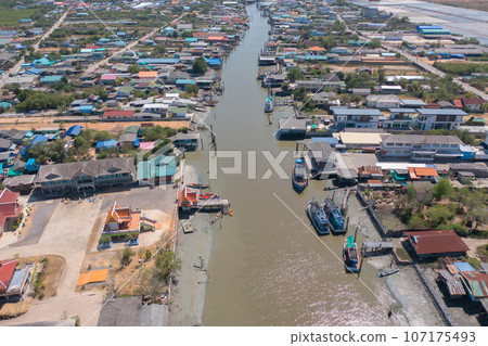 Aerial view of fishing trap net in canel with fisherman urban city village town houses, lake or river. Nature landscape fisheries and fishing tools at Pak Pha, Songkhla, Thailand. Aquaculture farming Aerial view of fishing trap net in canel with fisherman urban city village town houses, lake or river. Nature landscape fisheries and fishing tools at Pak Pha, Songkhla, Thailand. Aquaculture farming 107175493