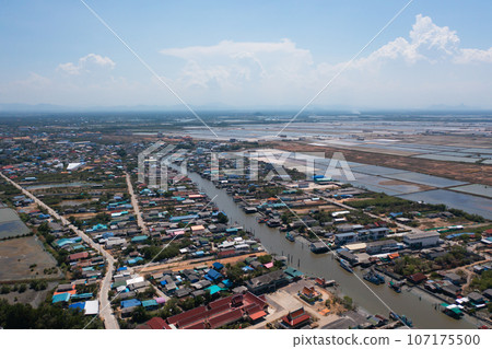 Aerial view of fishing trap net in canel with fisherman urban city village town houses, lake or river. Nature landscape fisheries and fishing tools at Pak Pha, Songkhla, Thailand. Aquaculture farming Aerial view of fishing trap net in canel with fisherman urban city village town houses, lake or river. Nature landscape fisheries and fishing tools at Pak Pha, Songkhla, Thailand. Aquaculture farming 107175500