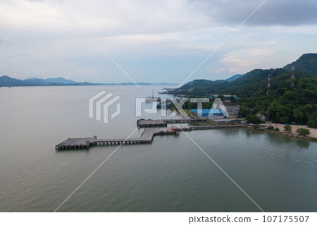 Aerial view of fishing trap net in canel with fisherman urban city village town houses, lake or river. Nature landscape fisheries and fishing tools at Pak Pha, Songkhla, Thailand. Aquaculture farming 107175507