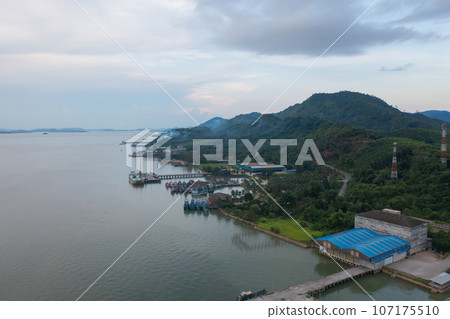 Aerial view of fishing trap net in canel with fisherman urban city village town houses, lake or river. Nature landscape fisheries and fishing tools at Pak Pha, Songkhla, Thailand. Aquaculture farming Aerial view of fishing trap net in canel with fisherman urban city village town houses, lake or river. Nature landscape fisheries and fishing tools at Pak Pha, Songkhla, Thailand. Aquaculture farming 107175510