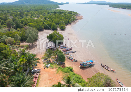 Aerial view of fishing trap net in canel with fisherman urban city village town houses, lake or river. Nature landscape fisheries and fishing tools at Pak Pha, Songkhla, Thailand. Aquaculture farming Aerial view of fishing trap net in canel with fisherman urban city village town houses, lake or river. Nature landscape fisheries and fishing tools at Pak Pha, Songkhla, Thailand. Aquaculture farming 107175514