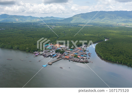 Aerial view of fishing trap net in canel with fisherman urban city village town houses, lake or river. Nature landscape fisheries and fishing tools at Pak Pha, Songkhla, Thailand. Aquaculture farming Aerial view of fishing trap net in canel with fisherman urban city village town houses, lake or river. Nature landscape fisheries and fishing tools at Pak Pha, Songkhla, Thailand. Aquaculture farming 107175520