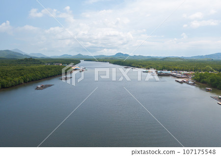 Aerial view of fishing trap net in canel with fisherman urban city village town houses, lake or river. Nature landscape fisheries and fishing tools at Pak Pha, Songkhla, Thailand. Aquaculture farming Aerial view of fishing trap net in canel with fisherman urban city village town houses, lake or river. Nature landscape fisheries and fishing tools at Pak Pha, Songkhla, Thailand. Aquaculture farming 107175548
