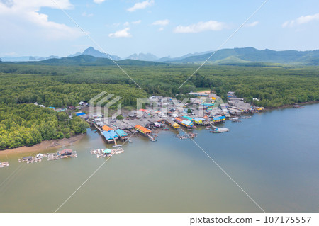 Aerial view of fishing trap net in canel with fisherman urban city village town houses, lake or river. Nature landscape fisheries and fishing tools at Pak Pha, Songkhla, Thailand. Aquaculture farming Aerial view of fishing trap net in canel with fisherman urban city village town houses, lake or river. Nature landscape fisheries and fishing tools at Pak Pha, Songkhla, Thailand. Aquaculture farming 107175557