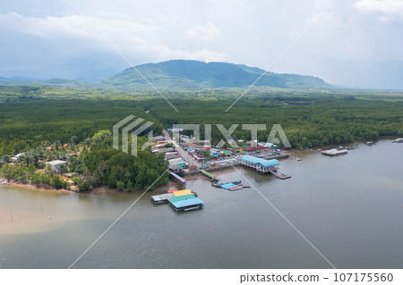 Aerial view of fishing trap net in canel with fisherman urban city village town houses, lake or river. Nature landscape fisheries and fishing tools at Pak Pha, Songkhla, Thailand. Aquaculture farming Aerial view of fishing trap net in canel with fisherman urban city village town houses, lake or river. Nature landscape fisheries and fishing tools at Pak Pha, Songkhla, Thailand. Aquaculture farming 107175560