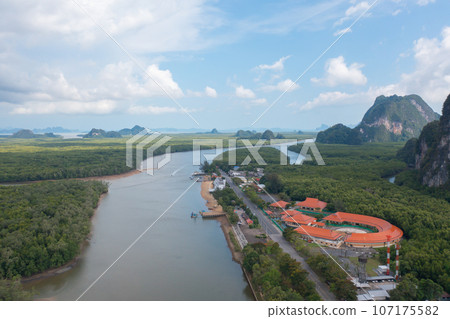 Aerial view of fishing trap net in canel with fisherman urban city village town houses, lake or river. Nature landscape fisheries and fishing tools at Pak Pha, Songkhla, Thailand. Aquaculture farming Aerial view of fishing trap net in canel with fisherman urban city village town houses, lake or river. Nature landscape fisheries and fishing tools at Pak Pha, Songkhla, Thailand. Aquaculture farming 107175582