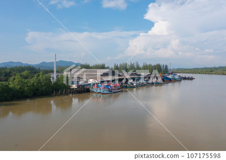 Aerial view of fishing trap net in canel with fisherman urban city village town houses, lake or river. Nature landscape fisheries and fishing tools at Pak Pha, Songkhla, Thailand. Aquaculture farming Aerial view of fishing trap net in canel with fisherman urban city village town houses, lake or river. Nature landscape fisheries and fishing tools at Pak Pha, Songkhla, Thailand. Aquaculture farming 107175598