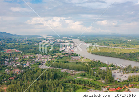 Aerial view of fishing trap net in canel with fisherman urban city village town houses, lake or river. Nature landscape fisheries and fishing tools at Pak Pha, Songkhla, Thailand. Aquaculture farming Aerial view of fishing trap net in canel with fisherman urban city village town houses, lake or river. Nature landscape fisheries and fishing tools at Pak Pha, Songkhla, Thailand. Aquaculture farming 107175610