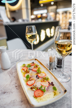 Sea bass ceviche with strawberry, kiwi and mango salsa 107176278