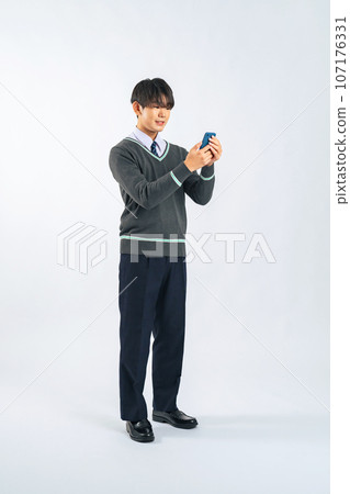 Male student using a smartphone (cutout PNG also available for sale! See author link) Male student using a smartphone (cutout PNG also available for sale! See author link) 107176331