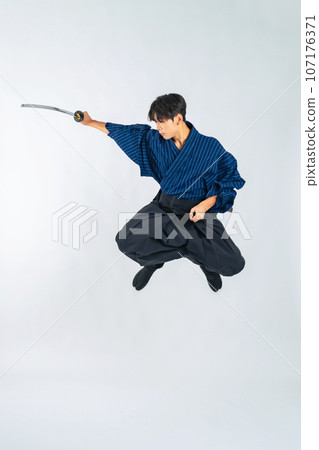 A boy jumping and swinging a Japanese sword, Samurai, martial arts (cutout PNG is also on sale! See author link) 107176371