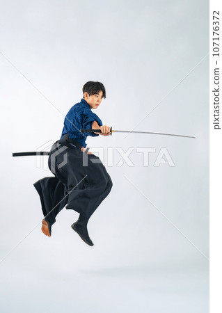 A boy jumping and swinging a Japanese sword, Samurai, martial arts (cutout PNG is also on sale! See author link) 107176372