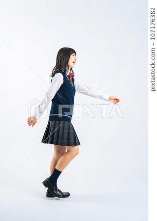 Female student in uniform walking (cutout PNG also available for sale! See author link) 107176382