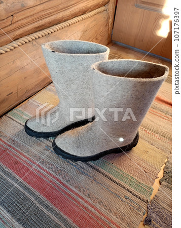 felt boots on the floorboard in a country house felt boots on the floorboard in a country house 107176397