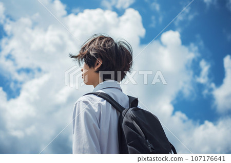 Rear view of a high school boy looking up at the sky Rear view of a high school boy looking up at the sky 107176641