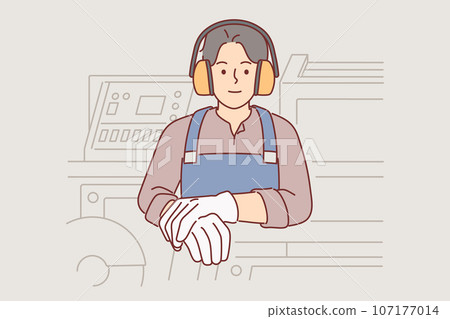 Industrial factory worker man in headphones protecting ears stands near milling machine Industrial factory worker man in headphones protecting ears stands near milling machine 107177014