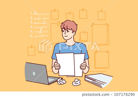 Man freelancer is doing paperwork, sitting at office table with laptop and documents Man freelancer is doing paperwork, sitting at office table with laptop and documents 107178290