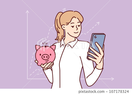 Woman accountant with piggy bank and phone is standing near financial chart calling to investing Woman accountant with piggy bank and phone is standing near financial chart calling to investing 107178324