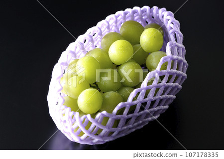 黑色背景下戴著水果帽的 Shine Muscat 的照片 107178335