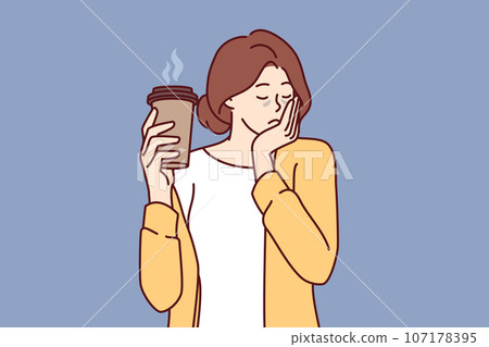 Sleepy woman holds paper cup of coffee and falls asleep standing up due to severe exhaustion Sleepy woman holds paper cup of coffee and falls asleep standing up due to severe exhaustion 107178395