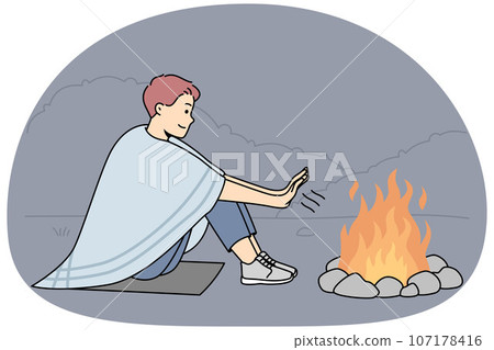 Young man warm hands at fire 107178416