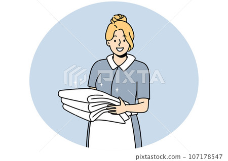 Smiling housekeeper with stack of towels Smiling housekeeper with stack of towels 107178547