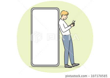 Young man near huge cell with mockup screen Young man near huge cell with mockup screen 107178585