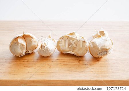 Six white cloves of fresh garlic 107178724