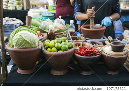 Clay bowls with fresh vegetables cabbage, lime and chili peppers Clay bowls with fresh vegetables cabbage, lime and chili peppers 107178821