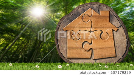 Wooden House Made of Jigsaw Puzzle Pieces on a Tree Trunk Wooden House Made of Jigsaw Puzzle Pieces on a Tree Trunk 107179259