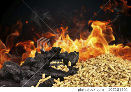 wood pellets and pieces of coal with flames 107181301