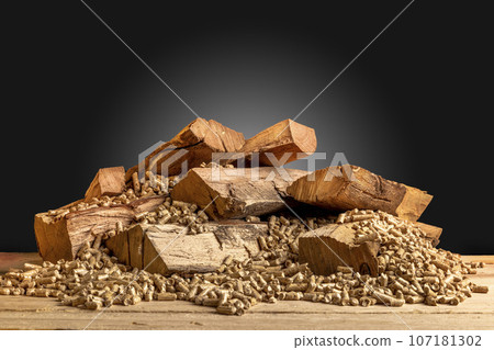 wood pellets and logs on a dark 107181302