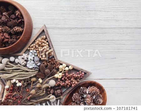 dried flowers on a wooden plate 107181741