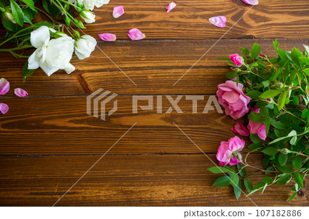 Floral background of pink and white roses on a dark wooden Floral background of pink and white roses on a dark wooden 107182886