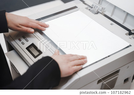 Office Woman's hand with working copier scanner 107182962
